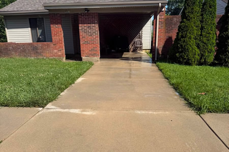Technician performing driveway pressure washing in a lexington ky neighborhood